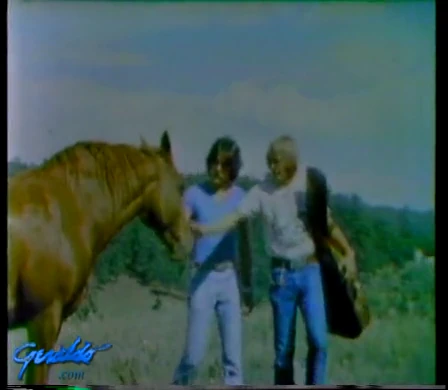 Geraldo Rivera and John Denver pet a horse